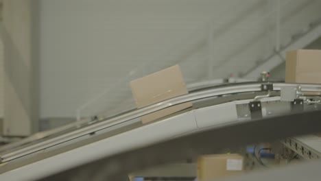 a cardboard box travels on a conveyor belt in a warehouse distribution center