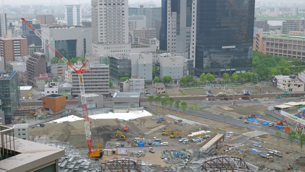 Timelapse zooming out from a railway station construction site in Osaka