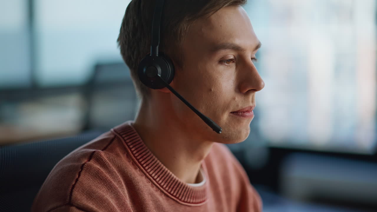 Helpline operator wearing headset providing computer consultation office closeup