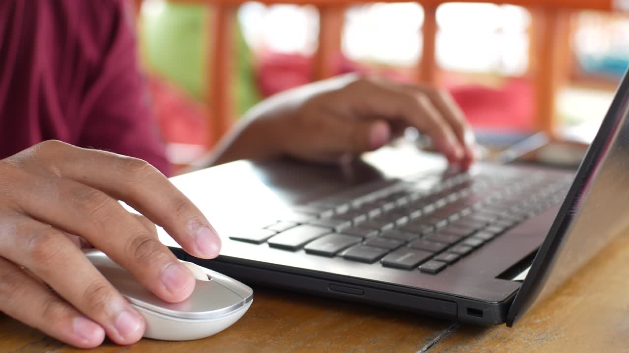 hand typing laptop and using mouse. someone working with laptop