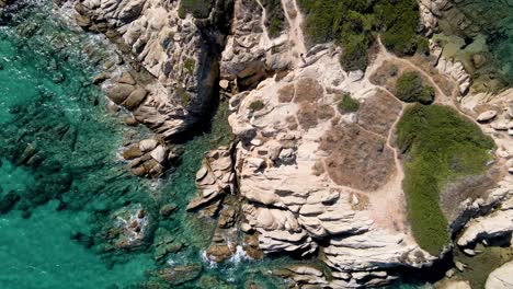 Aerial-drone-clip-over-a-rock-formation-in-an-exotic-beach-in-Vourvourou,-Chalkidiki,-Greece