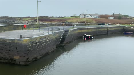 establishing pan across tarrea pier galway with empty boat ramp