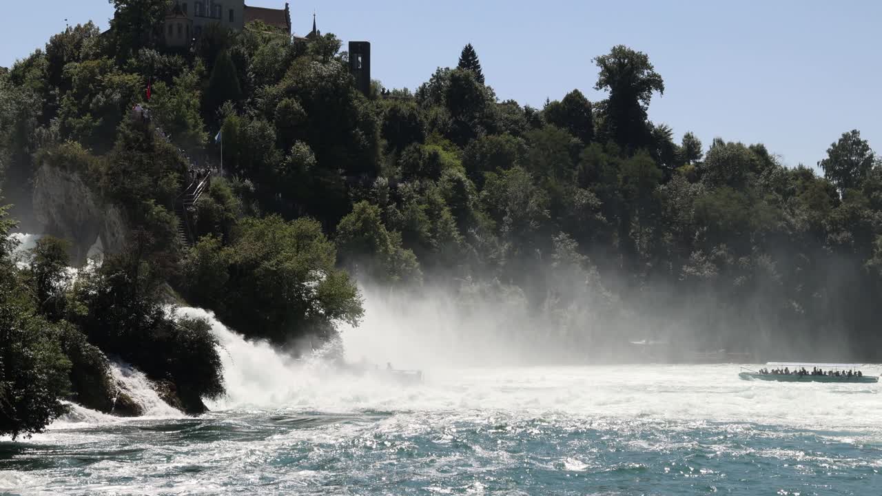 Tourist boats approaching Rhine falls waterfall