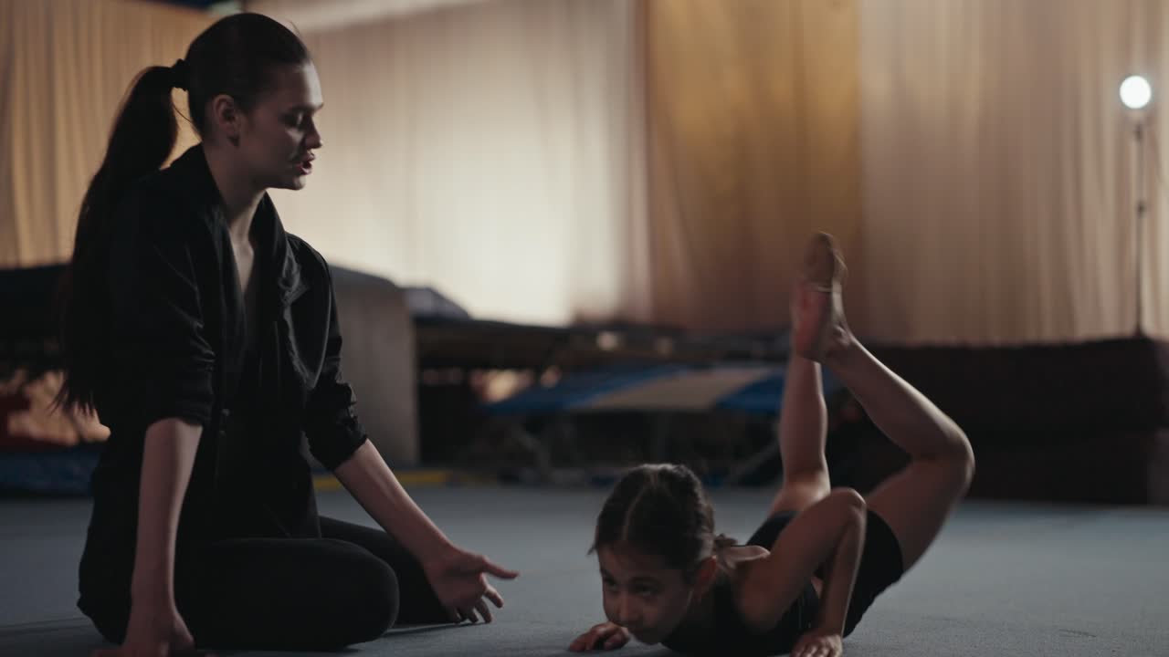 Young gymnast training with coach