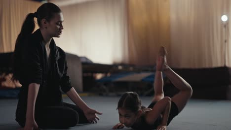 young gymnast training with coach