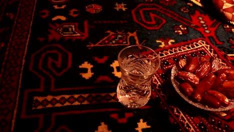 water and dates. iftar is the evening meal. slider view of decoration ramadan kareem holiday. festive greeting card, invitation for muslim holy month ramadan kareem. dark background. selective focus