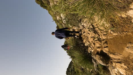 4k-Vertical-shot-of-tourists-hiking-on-a-path-at-La-Concha,-Marbella,-Spain