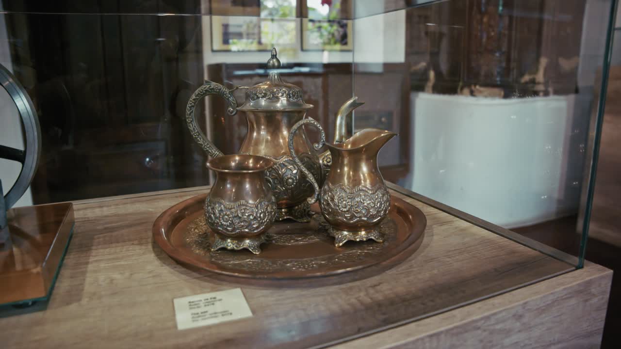Ornate antique metal tea set displayed in Kumrovec museum, showcasing craftsmanship