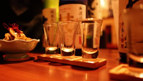 sequence of sake being poured into glasses