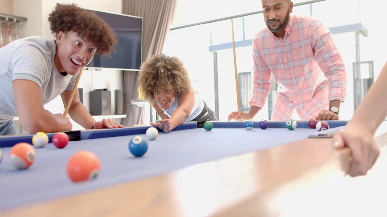 Playing pool, Diverse friends enjoying fun hangout together, smiling and laughing
