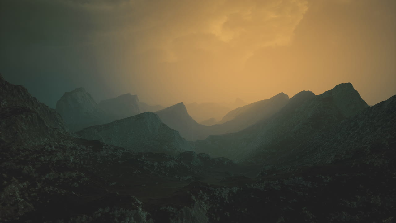 Misty mountains at dusk with golden hues illuminating the landscape