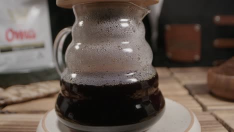 freshly brewed coffee in a glass jar, steam clinging to the surface, evokes warmth and comfort, capturing the essence of a cozy and authentic coffee ritual