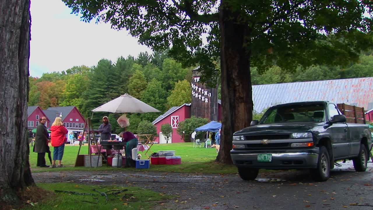 버몬트의 국가 박람회에서 나무와 붉은 헛간 근처에서 가족 피크닉