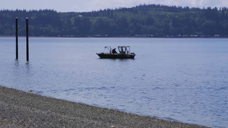 small, nondescript fishing floating near dock at camano island state park, wa state