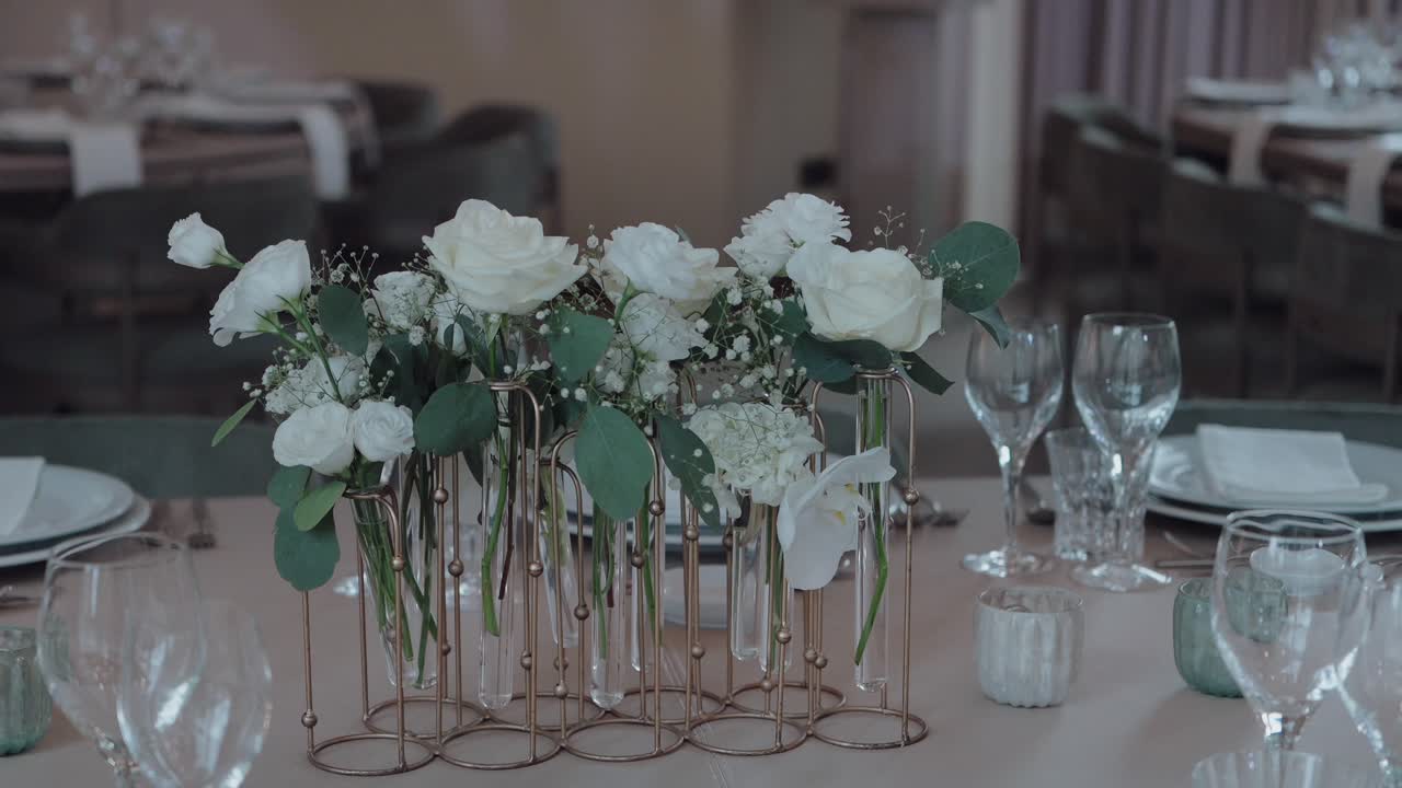 delicate white floral arrangement displayed on a formal dining table