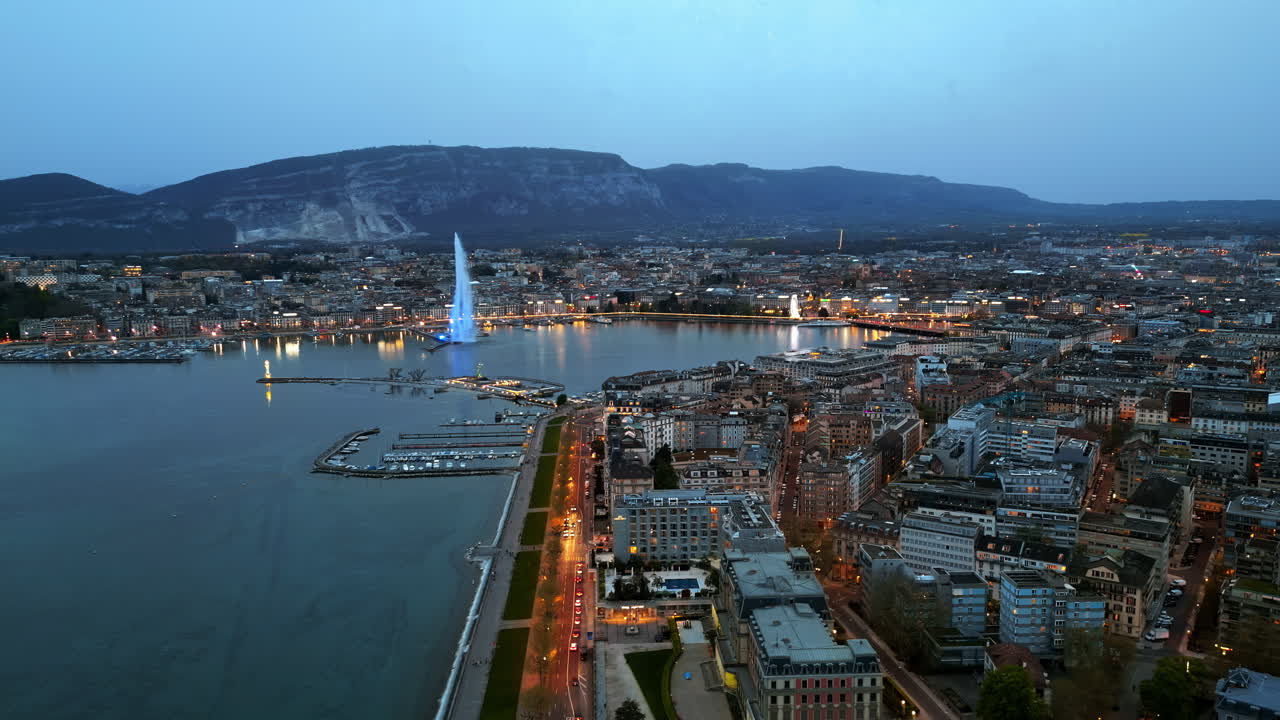 Aerial, drone view of the Geneva Water Fountain in Switzerland in the evening