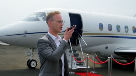 Businessman-talking-on-mobile-phone-at-terminal-4k