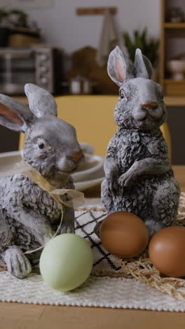 easter table setting with rabbits and eggs