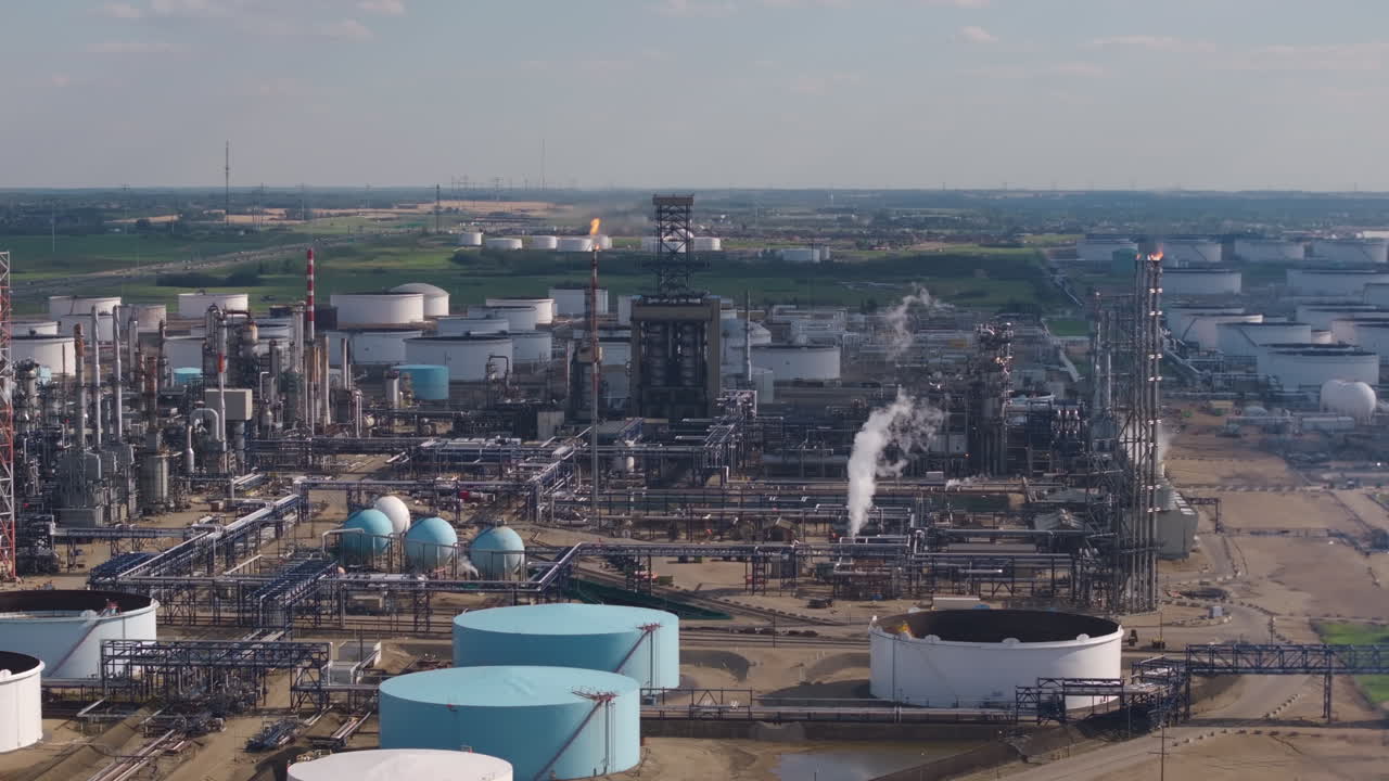 Aerial view of large industrial refinery under a sunny sky