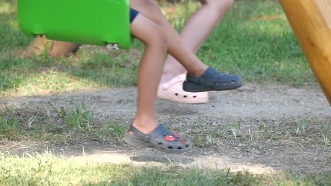 children playing on an outdoor swing set