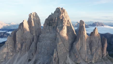 drone shot of famous tre cime di lavaredo towers in dolomites of italy during beautiful sunrise