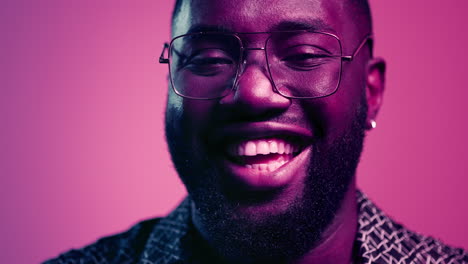 African-american-man-laughing-in-studio.-Natural-male-person-smiling-indoors