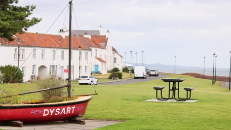 a red boat and coastal town view