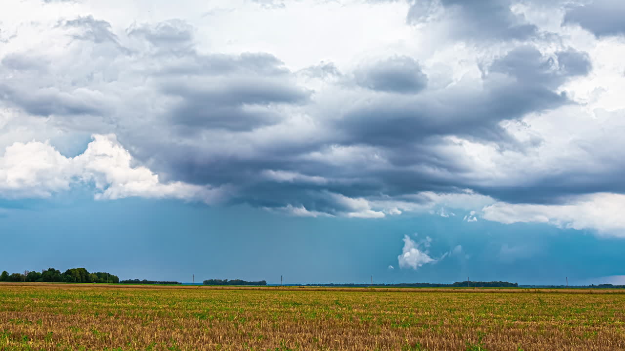 Timelapse of Developing Cloud Formations Over Latvia's Farmland with a Tractor Passing Across the Landscape