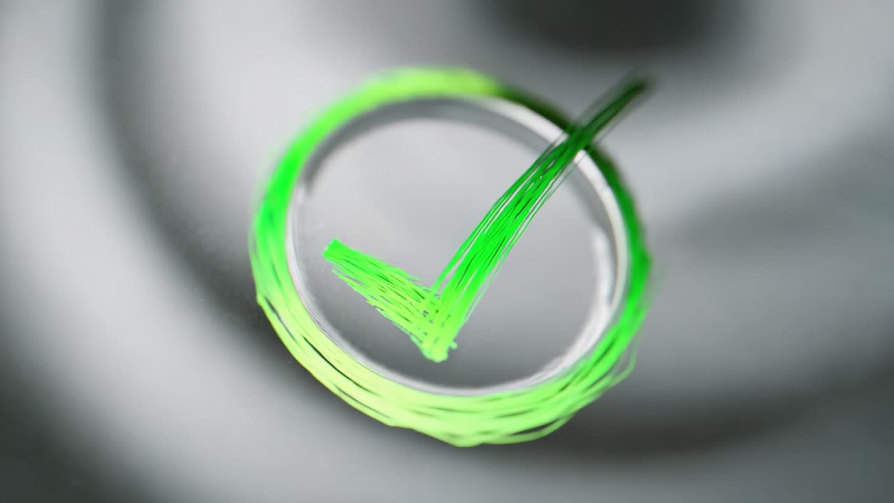 Close-up of a Green Check Mark in a Circular Design Representing Approval, Confirmation, and Success in a Minimalistic Setting of Soft Focus and Subtle Textures