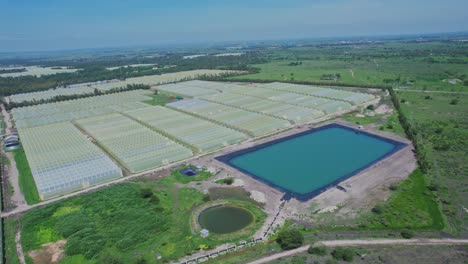 irrigation basin next to greenhouses on agricultural field in kenya