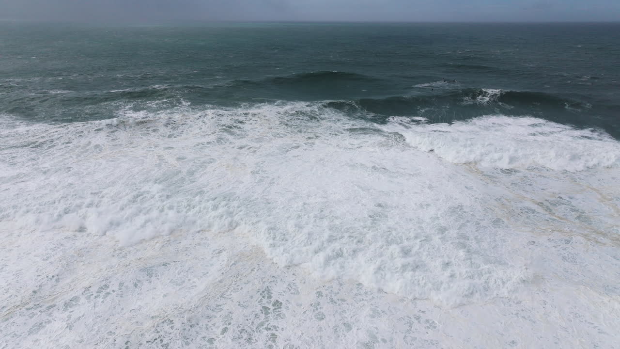 Giant swell at famous iconic Nazaré, nature aerial drone shot