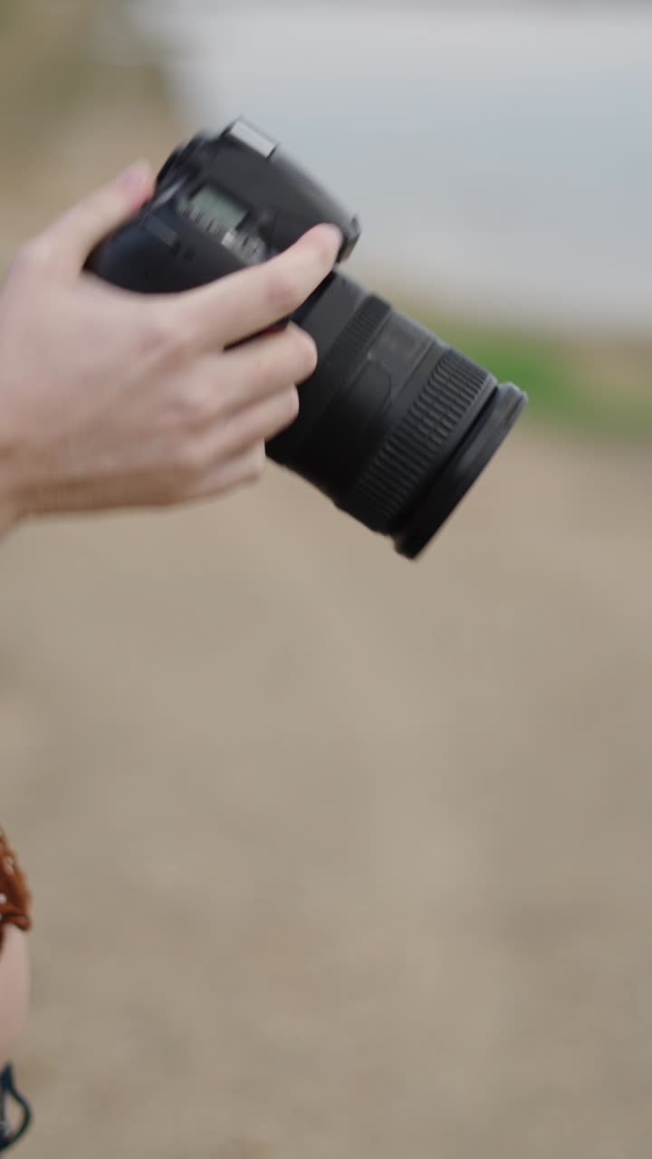 Woman holding a camera in an outdoor setting