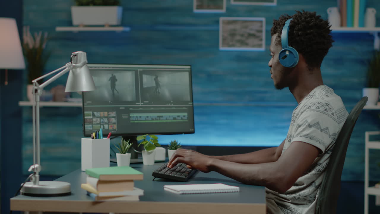 Videographer with headphones editing montage for music video