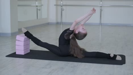 young ballerina practicing dance moves in studio