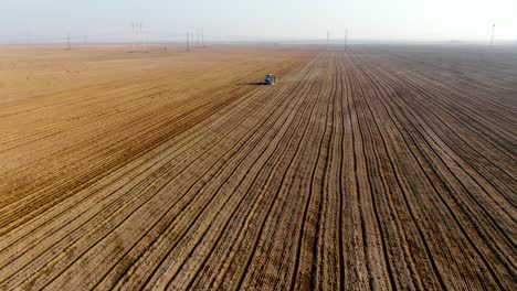 Combined-Tractor-Plowing-Field-On-Agricultural-Landscape