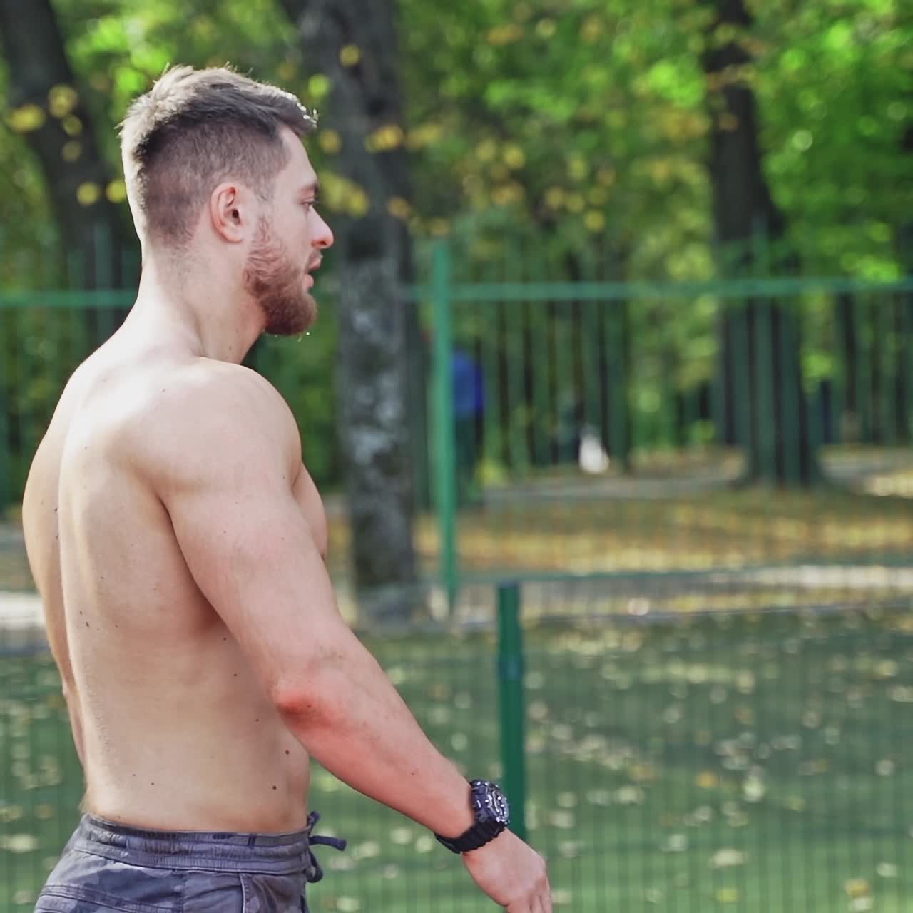 Muscular man posing on stadium