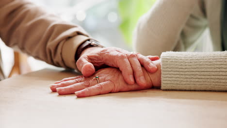 elderly couple holding hands