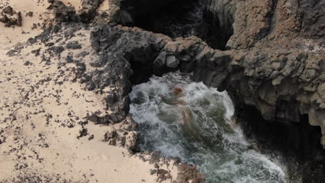 Aerial-shot-approaching-one-of-the-Caletones-arches-located-on-the-island-of-La-Graciosa