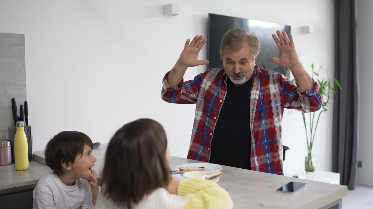 abuelo con nietos hablando en la cocina