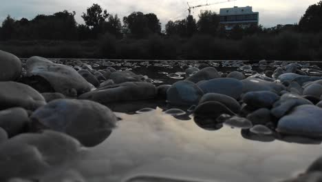 Calm-river-shoot-with-flowing-water-and-rocs-from-a-low-angle-in-the-afternoon-at-4k-24fps