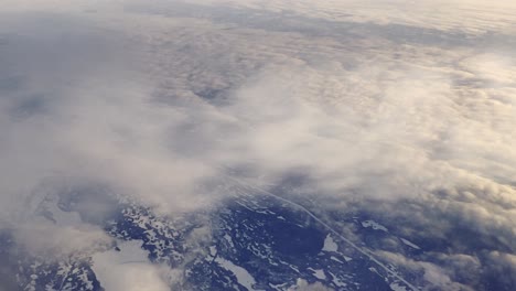 wilderness of newfoundland and labrador canadian region with airplane condensed air due to cold temperature aerial view