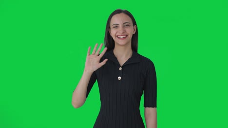 happy indian female news anchor saying hello green screen