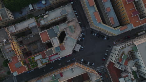 Top-down-panning-footage-of-blocks-of-apartment-buildings-and-streets-in-residential-urban-borough.-Rome,-Italy