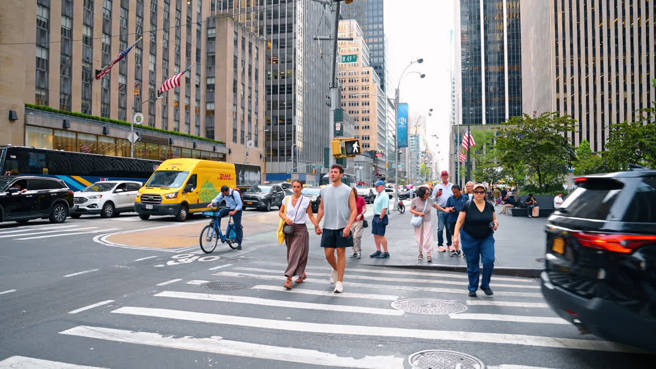 New York, USA, 2 October 2025: People stand at the crossroads waiting to cross the street. Walking by vibrant New York, USA at daytime