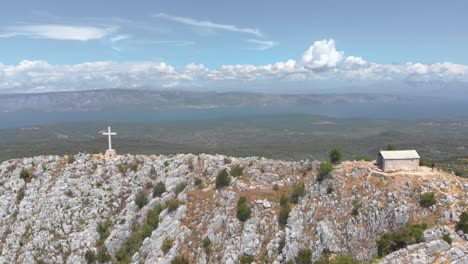 christianity cross on mountain peak on hvar island in croatia