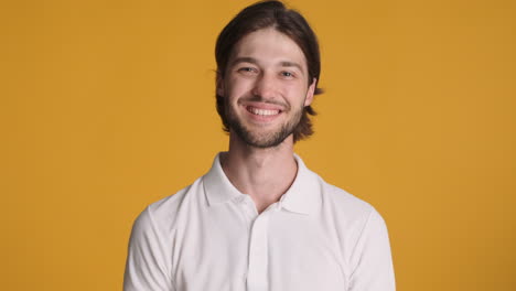 caucasian man in front of camera on yellow background.