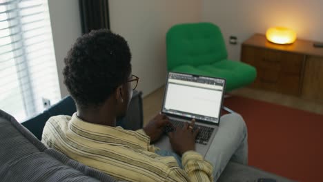 man working on a laptop at home
