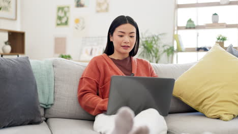 Remote-work,-smile-and-Asian-woman-on-sofa