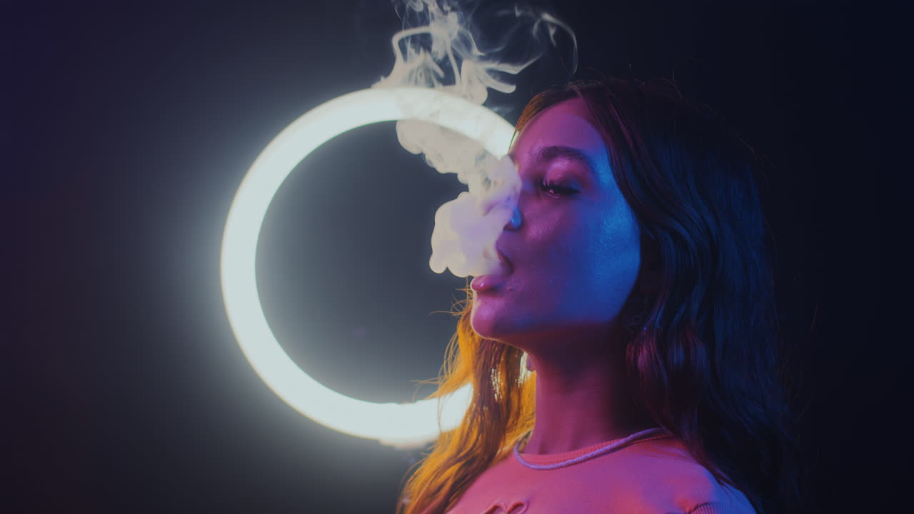 Woman Blowing Vape Smoke Clubbing in Neon