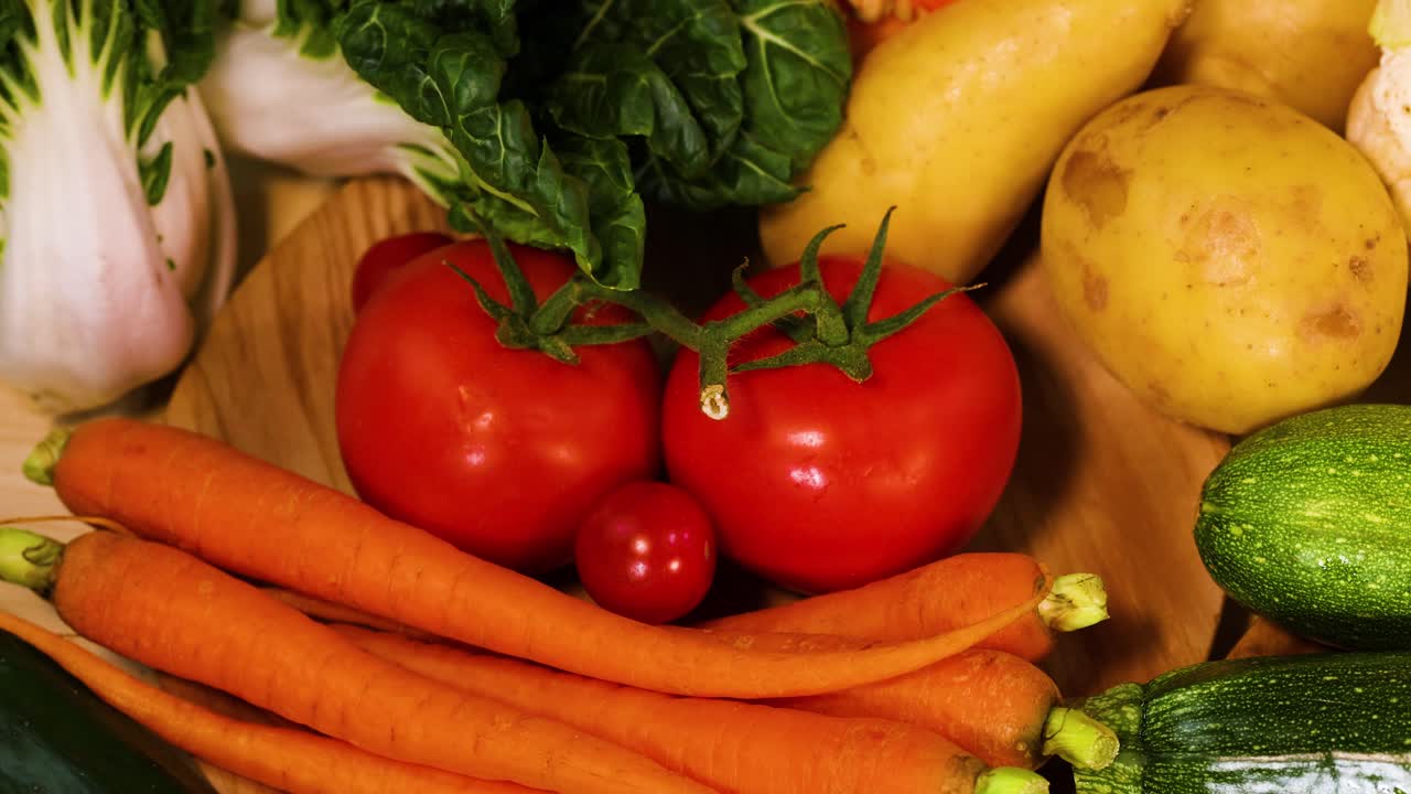 Assorted vegetables arranged on a black background